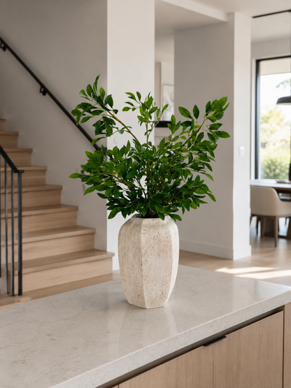 GREEN FOLIAGE ARRANGEMENT IN TEXTURED STONE VASE