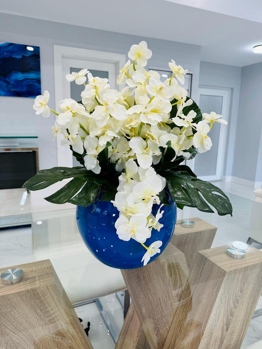 VANDA ORCHID AND MONSTERA LEAF IN BLUE VASE