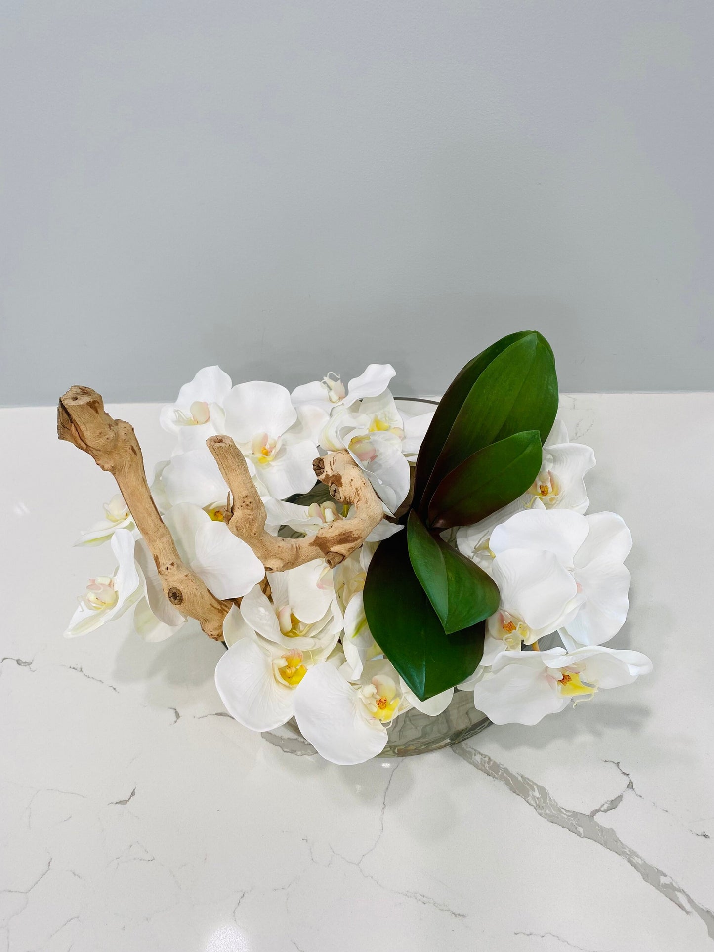 BOWL WITH WHITE ORCHIDS AND WOOD