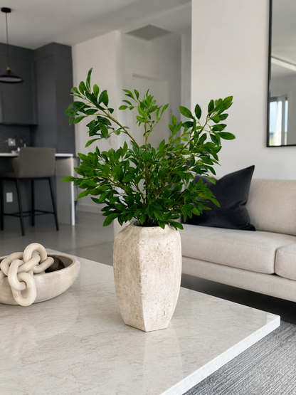 GREEN FOLIAGE ARRANGEMENT IN TEXTURED STONE VASE