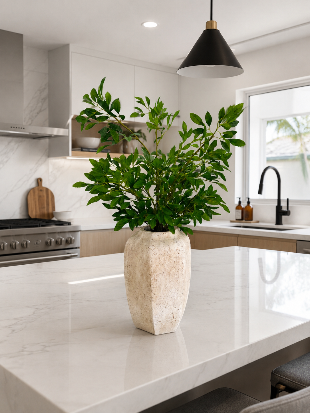 GREEN FOLIAGE ARRANGEMENT IN TEXTURED STONE VASE