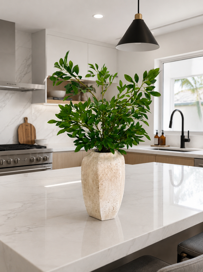 GREEN FOLIAGE ARRANGEMENT IN TEXTURED STONE VASE