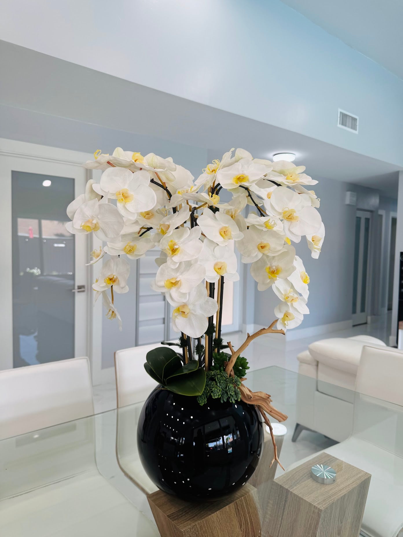 ORCHIDS IN BLACK GLASS VASE