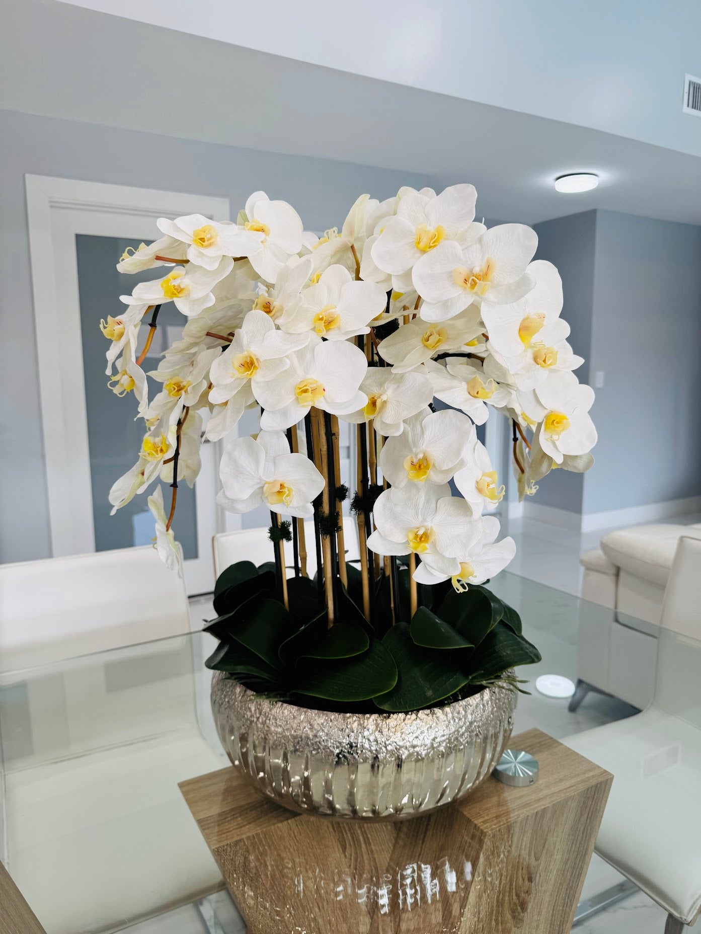 ORCHIDS IN SILVER METAL VASE