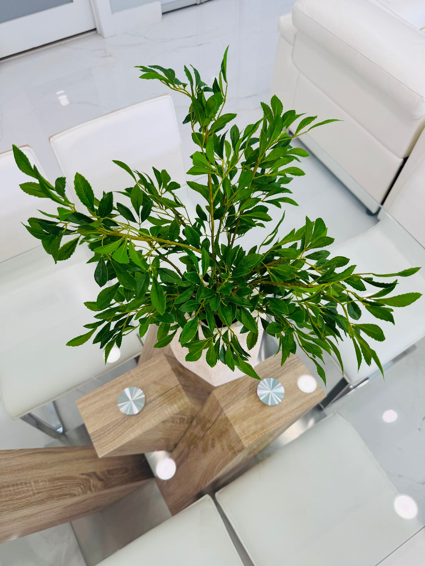 GREEN FOLIAGE ARRANGEMENT IN TEXTURED STONE VASE