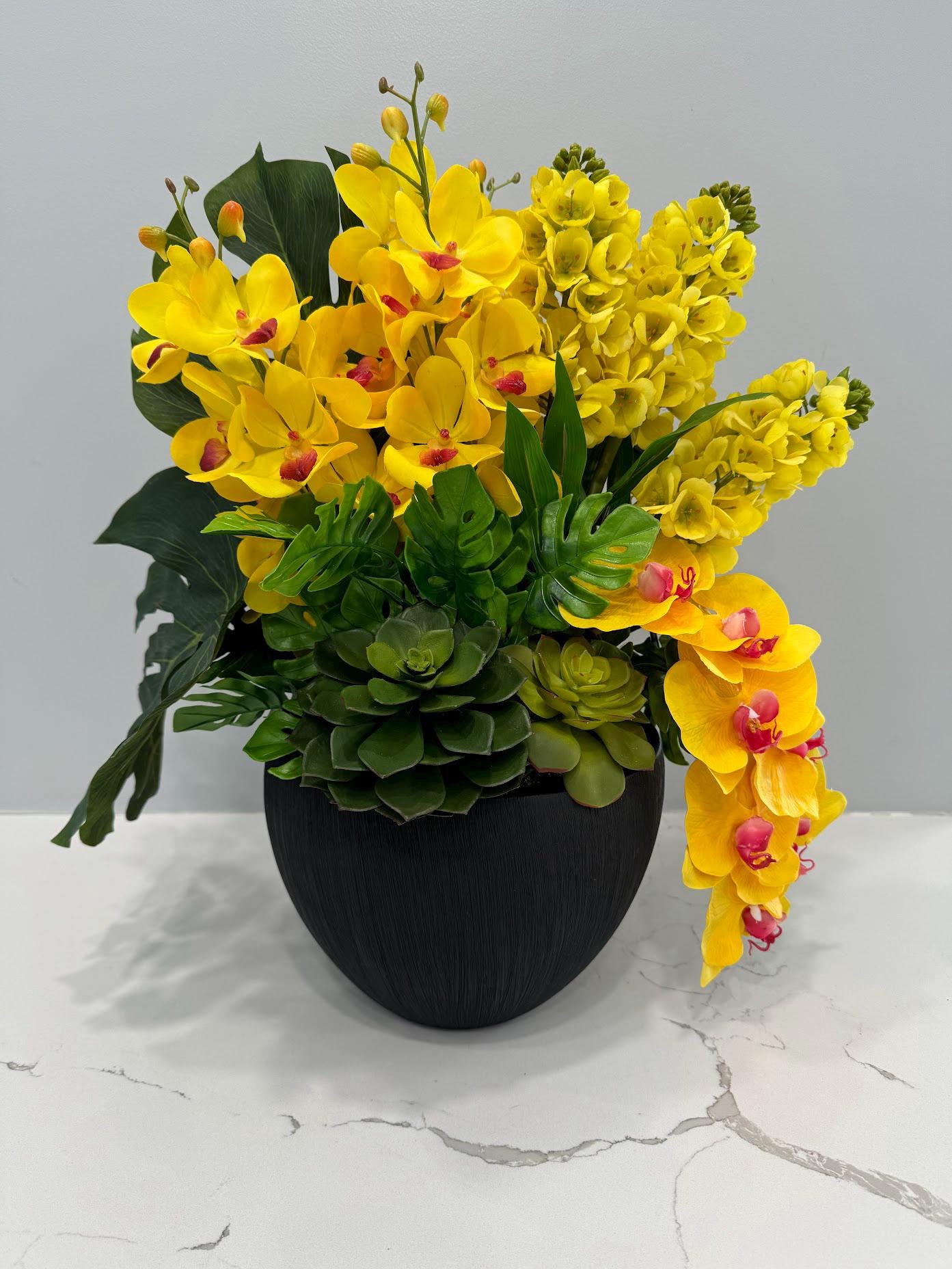 YELLOW ORCHIDS IN BLACK VASE
